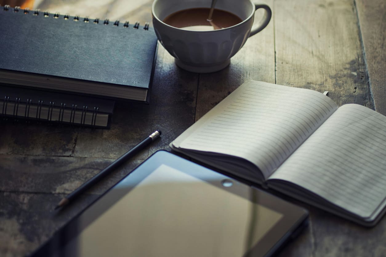 A cup of coffee and some books on the table