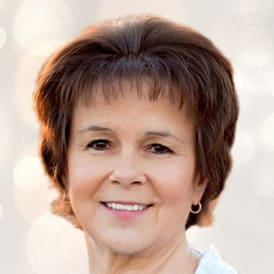 A woman with short hair is smiling for the camera.